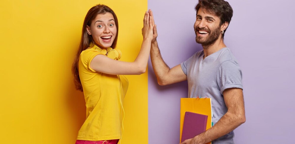 positive-young-woman-man-give-high-five-agree-work-as-team-stand-sideways-pq