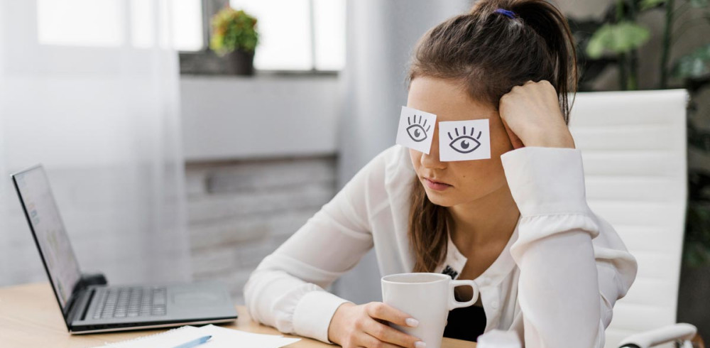 businesswoman-covering-her-eyes-with-drawn-eyes-paper-pq